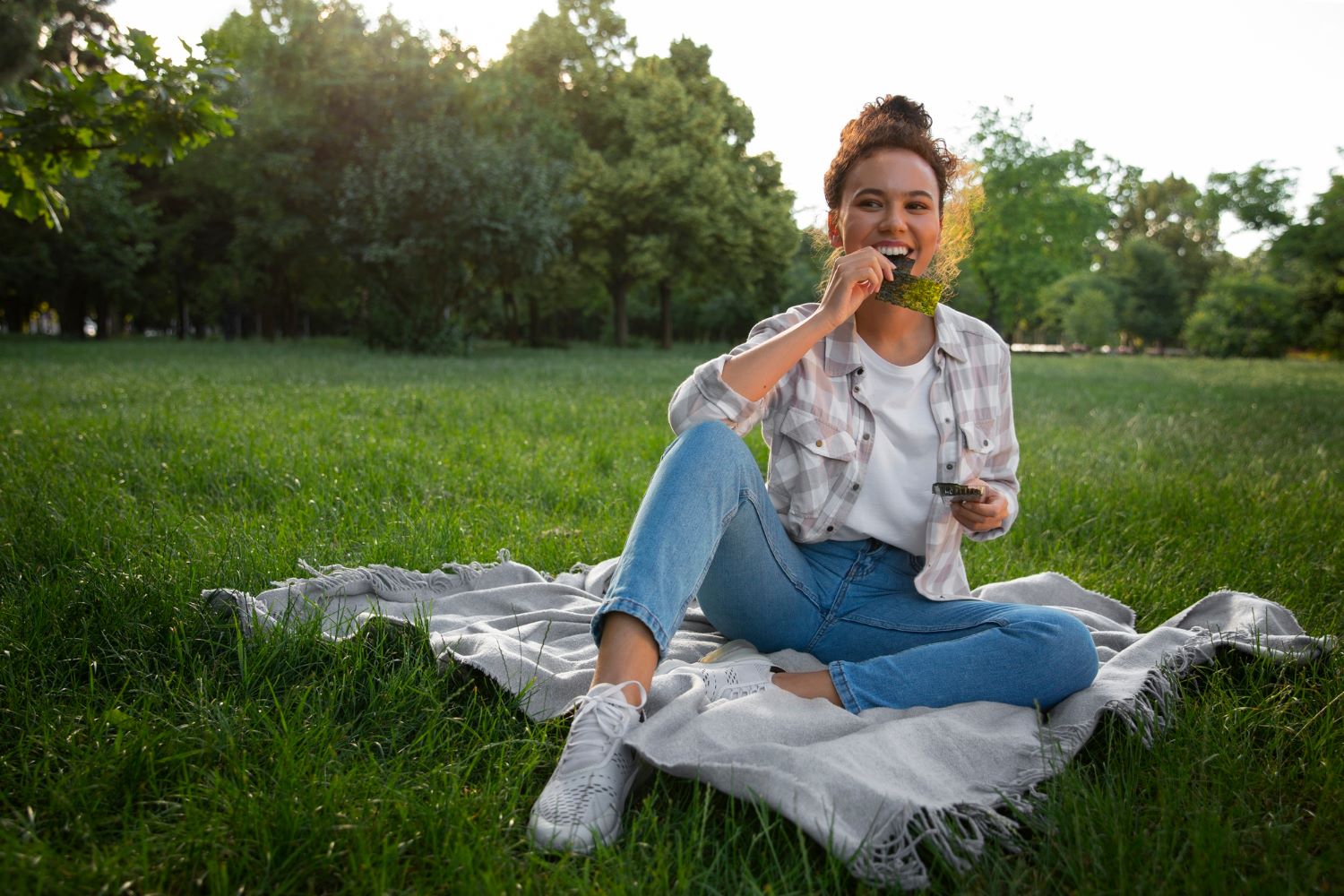 Woman relaxing outdoors and enjoying a quiet moment of summer self-care